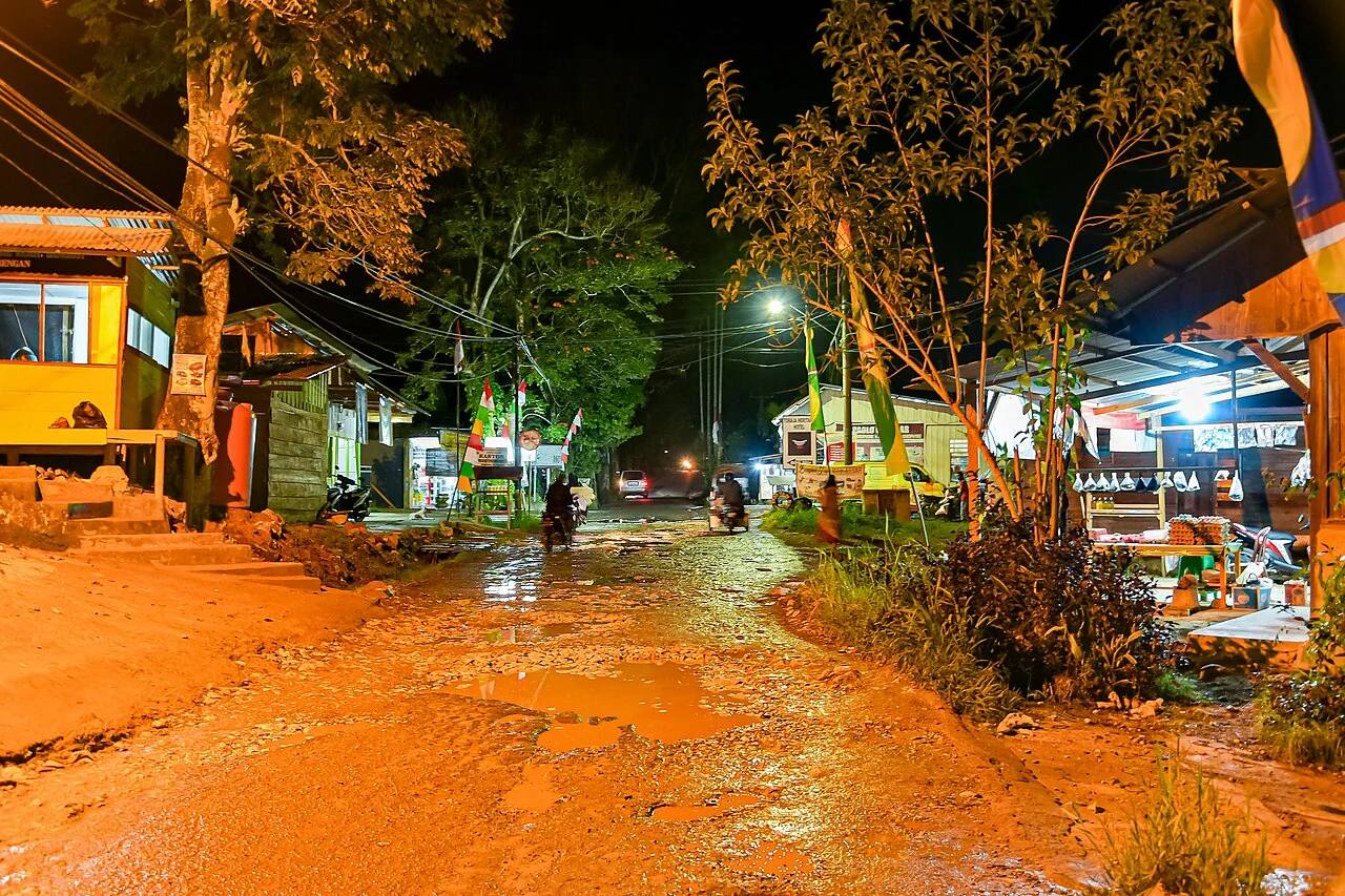 A street in Rantepao lit by shops after dark