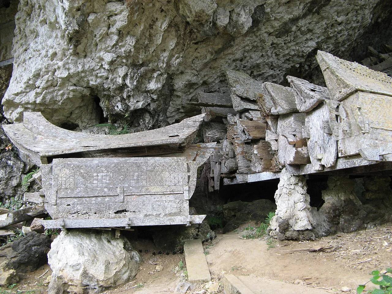 Wooden coffins beneath the burial cliff at Kete Kesu