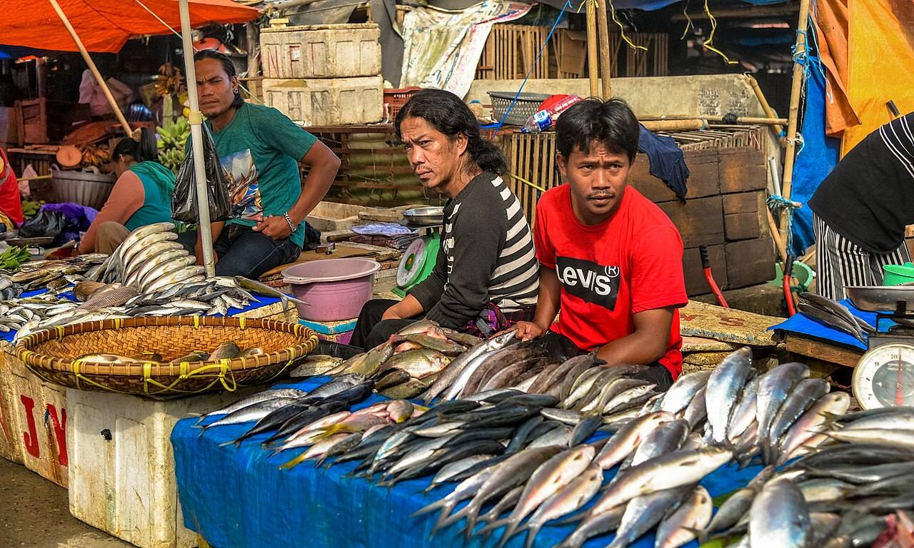 Fish sellers behind a fresh-fish stall at Pasar Bolu in Rantepao