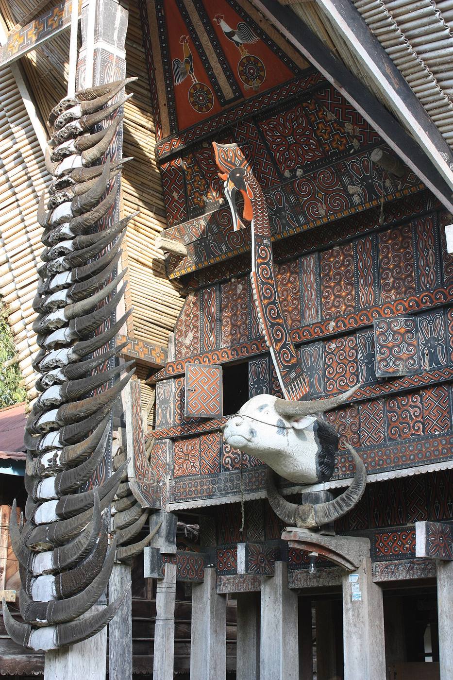 Stacked buffalo horns and carved panels on a tongkonan at Kete Kesu
